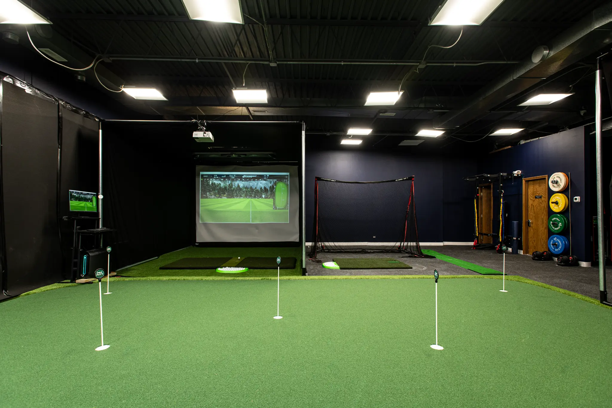 Precision Golf Training indoor facility overview — simulator bays, putting green, and fitness area in Libertyville IL