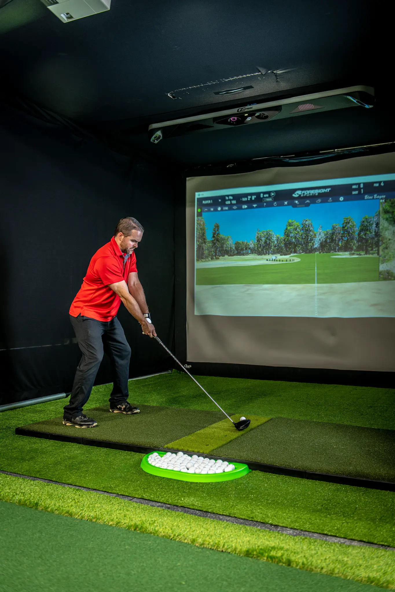 Golfer practicing putting at Precision Golf Training indoor facility in Libertyville IL